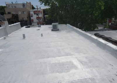 Close up of silver coating on flat roof install in Chicago